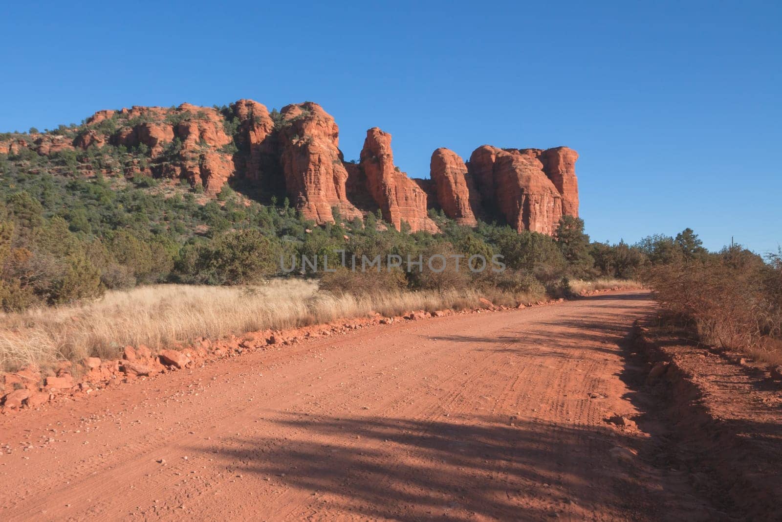 Dirt road through the red desert of Sedona, Arizona through Red Rocks.