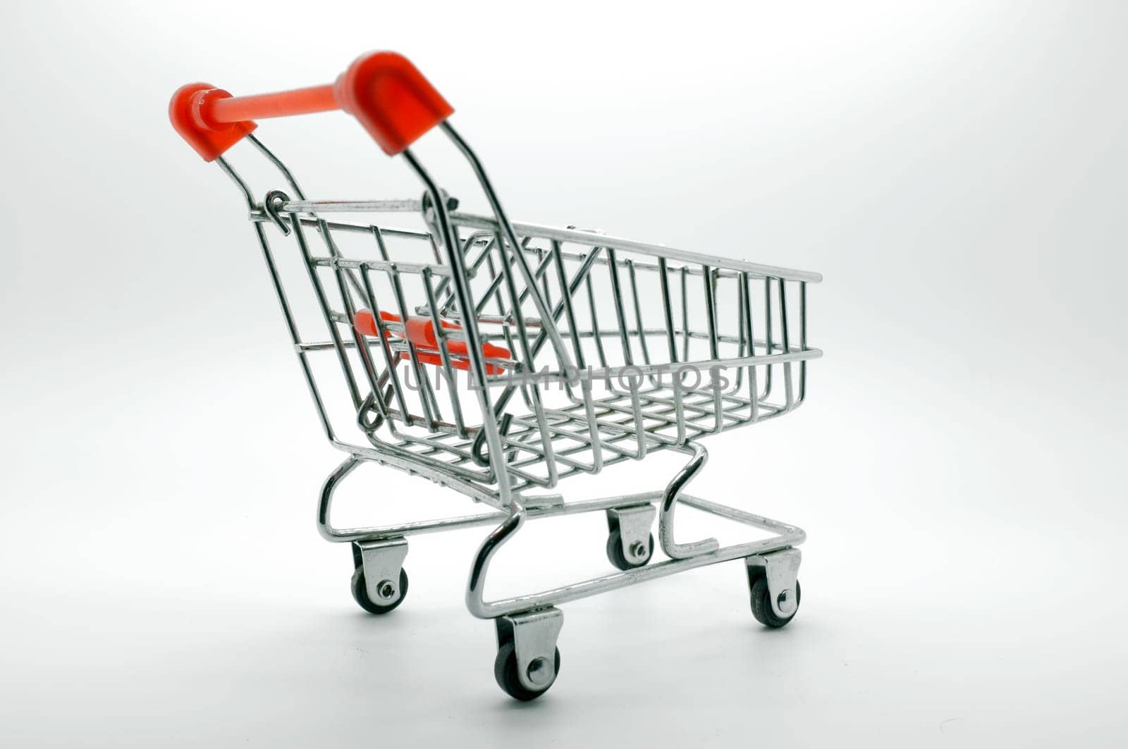Empty shopping cart, side view, on white background