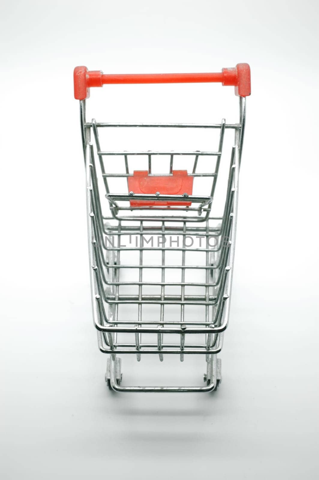Empty shopping cart, side view, on white background