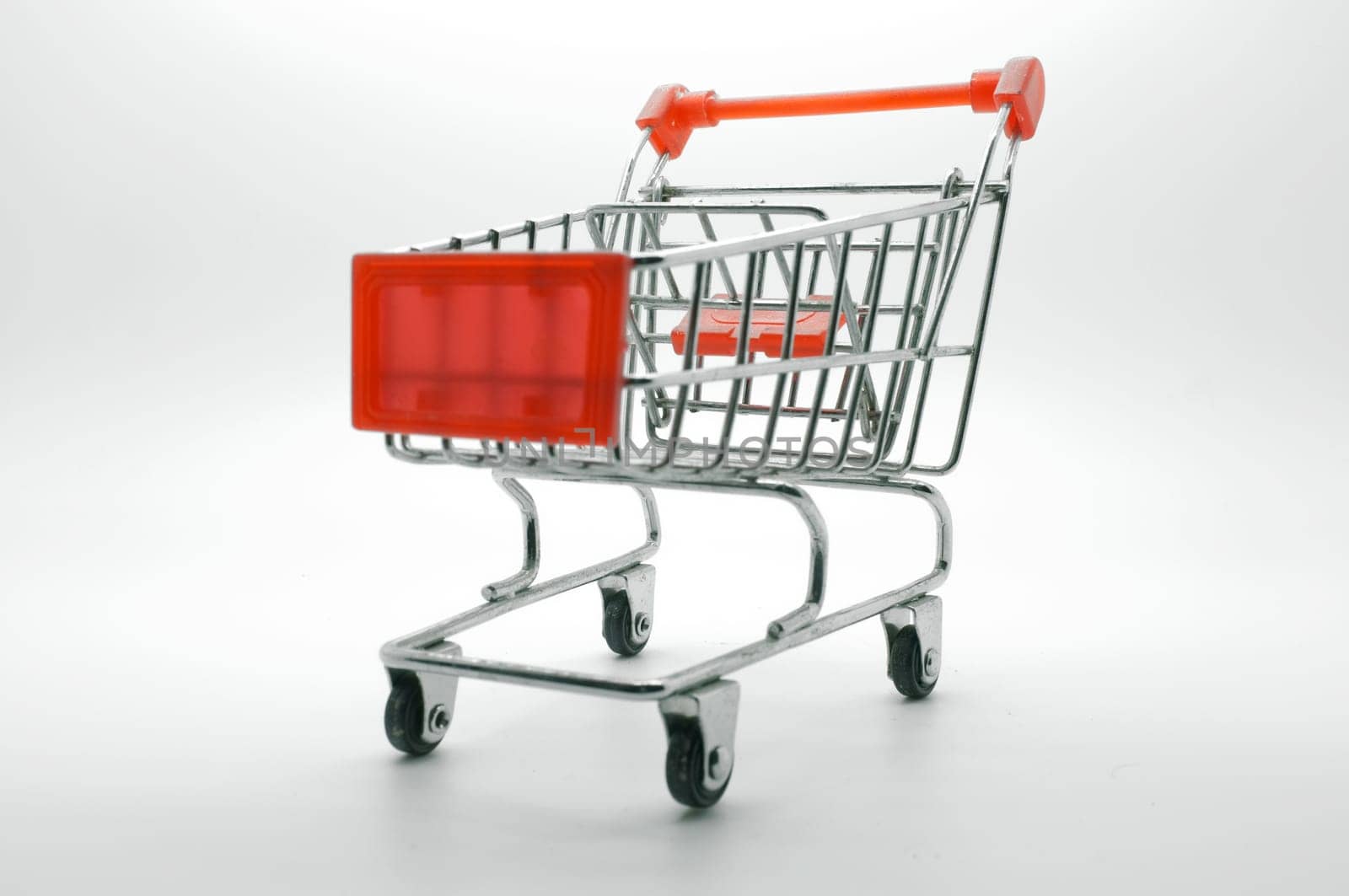 Empty shopping cart, side view, on white background