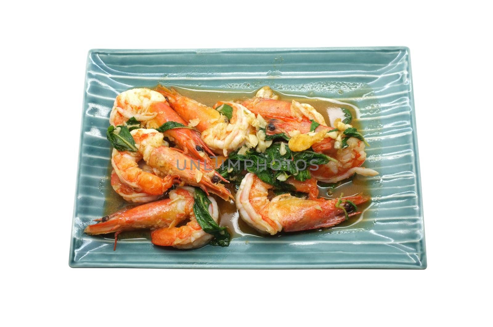 Shrimps fried with fresh herbs in dish isolated on white background