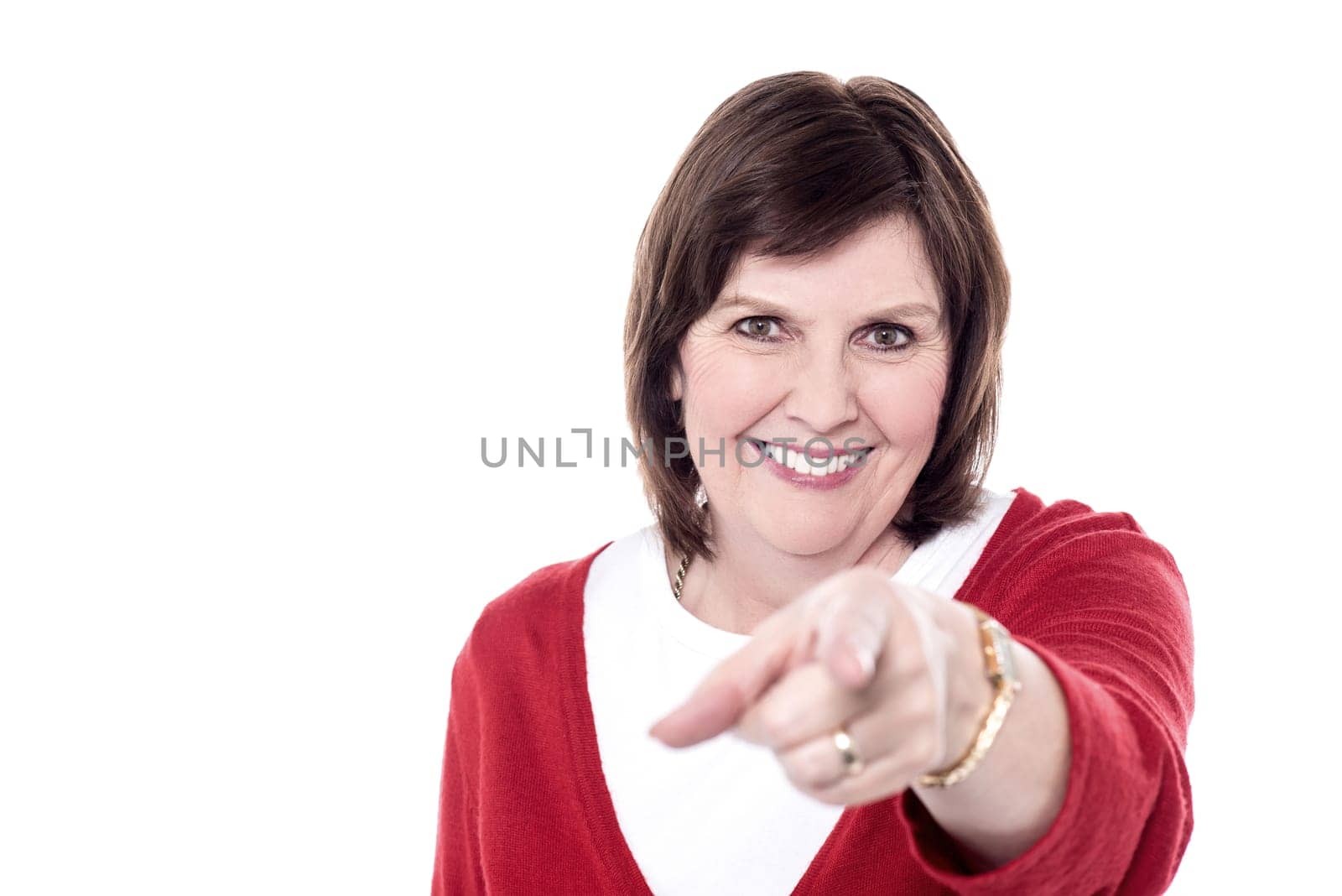Woman pointing fingers towards camera over white