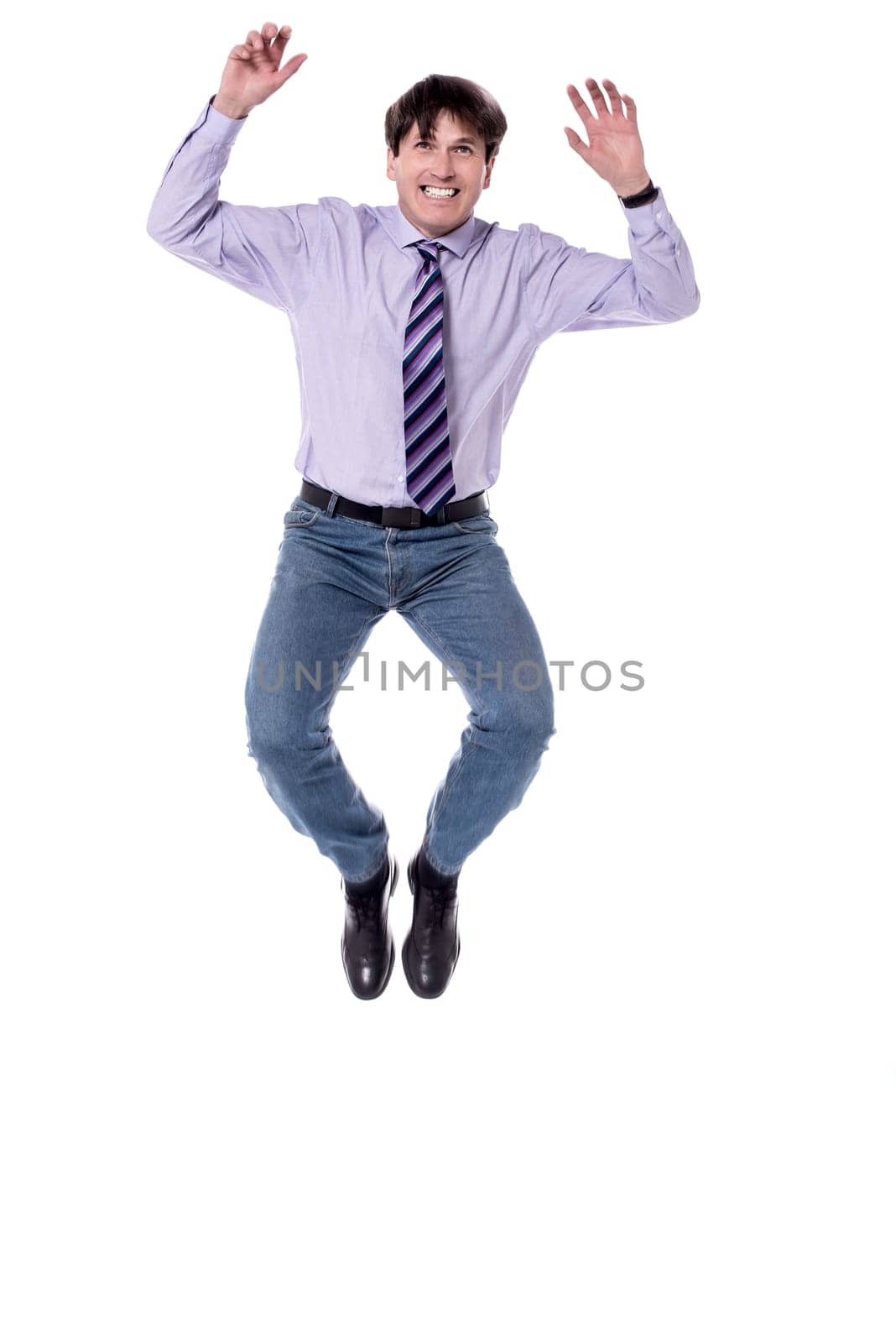 Businessman jumping in air against white background