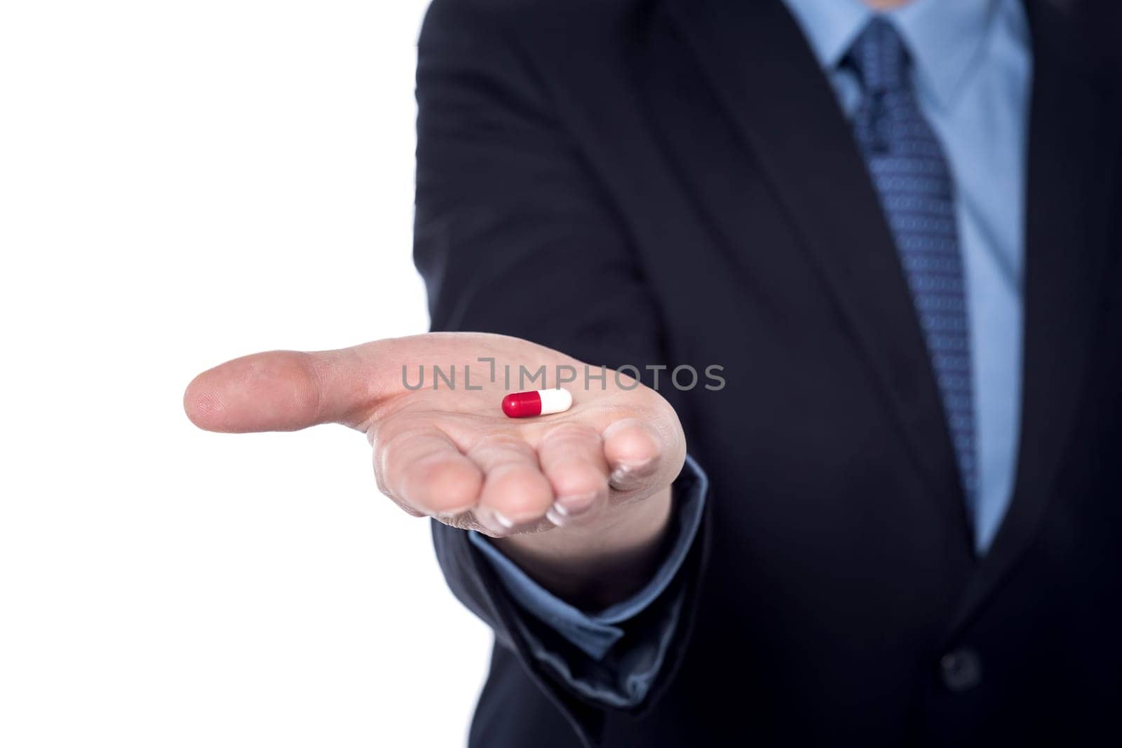 Cropped image of a businessman holding pill in his hand