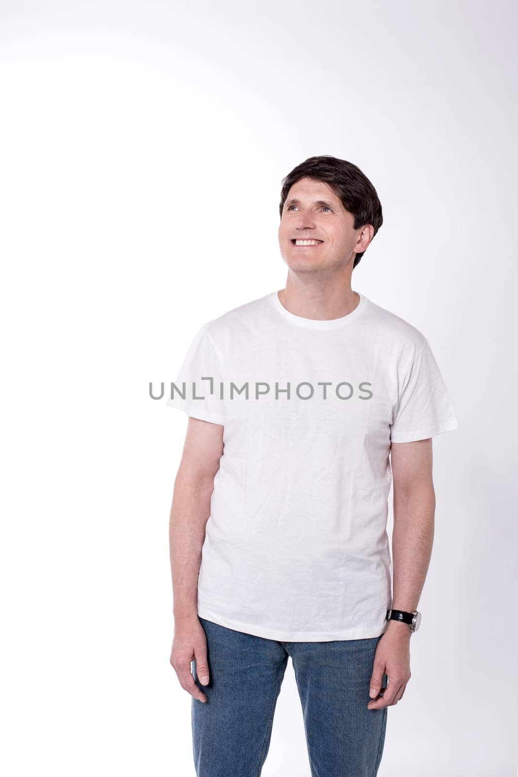 Casual man looking up against white background