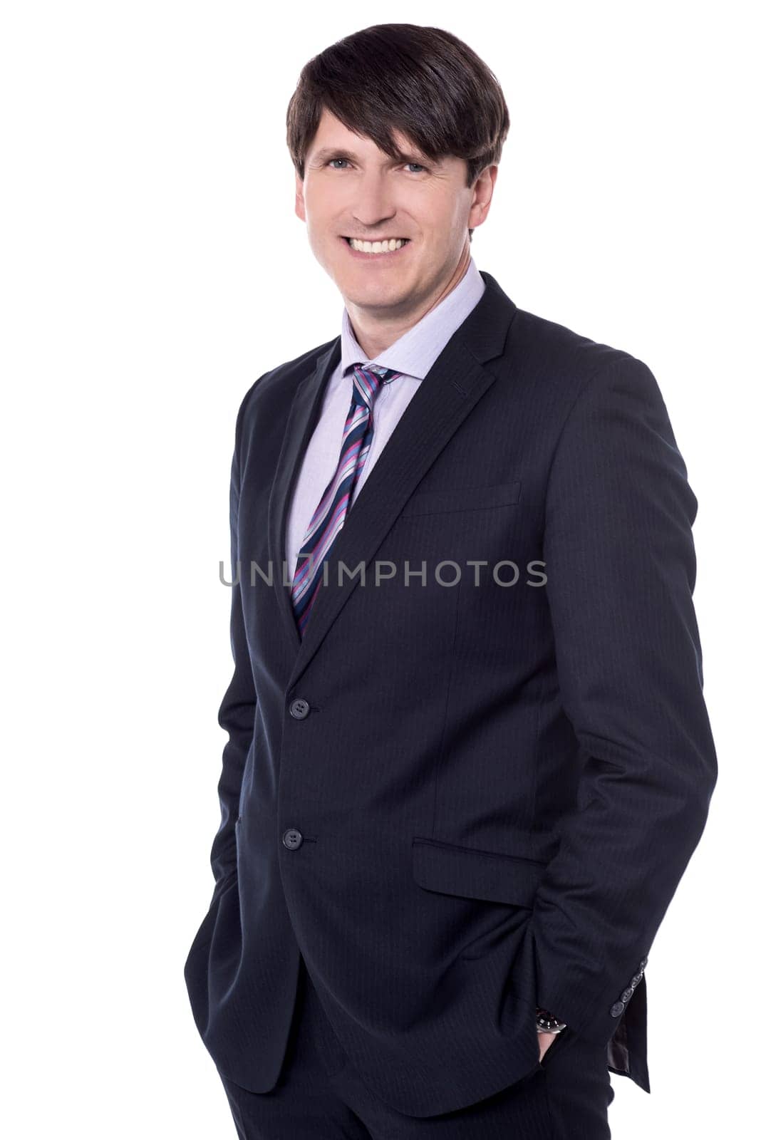 Smiling male entrepreneur posing with hands in pockets