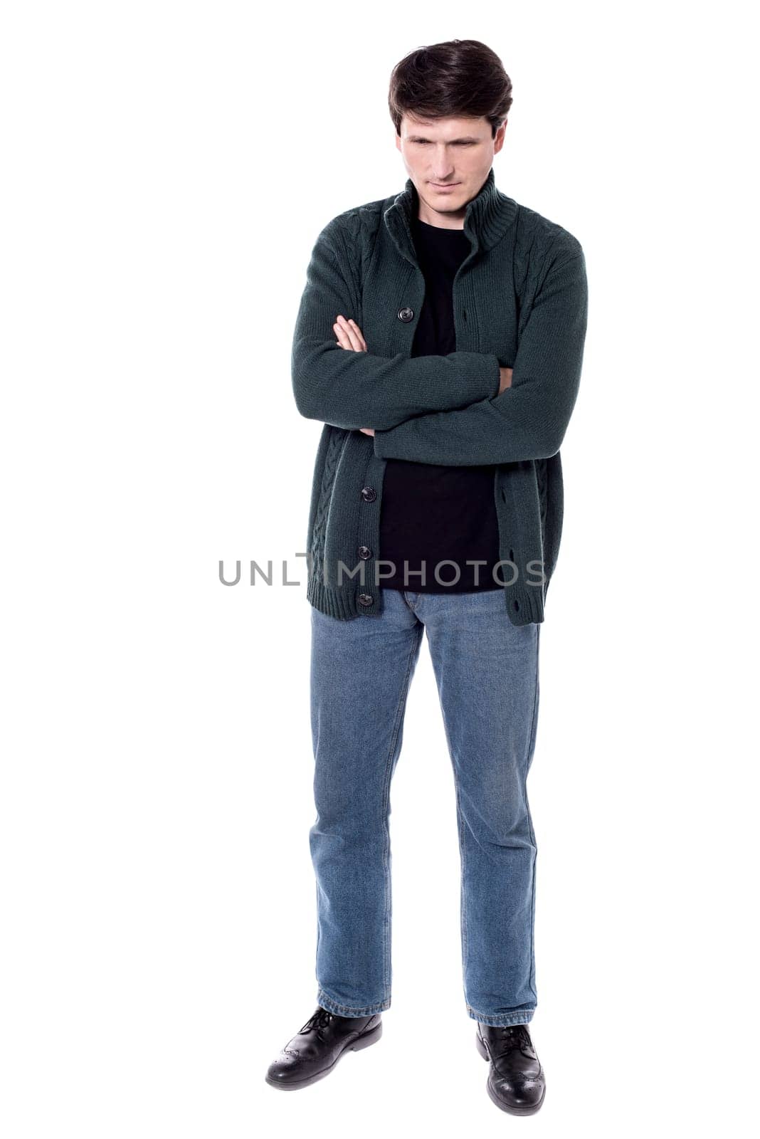 Man looking down with folded arms over white