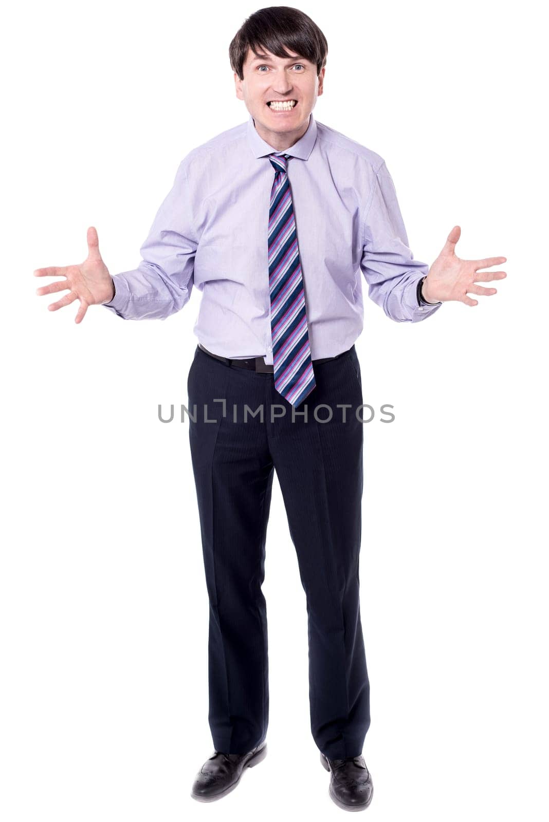 Irritated businessman with open arms against white background