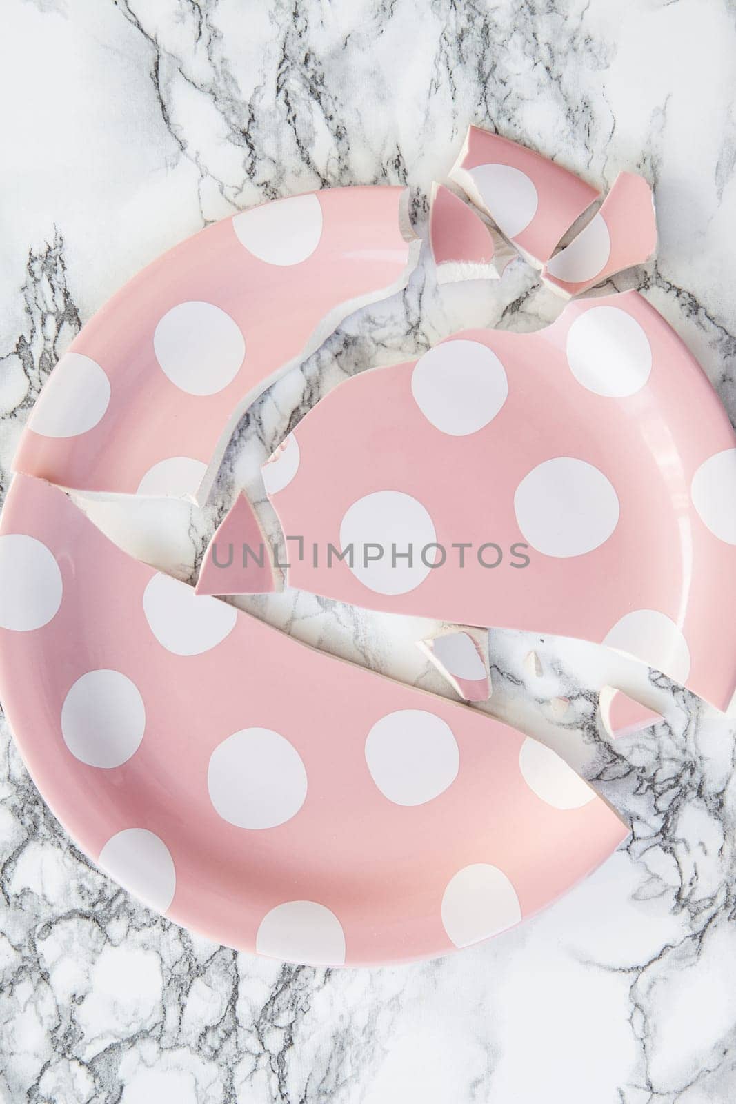 Plates in broken thighs on background in marble