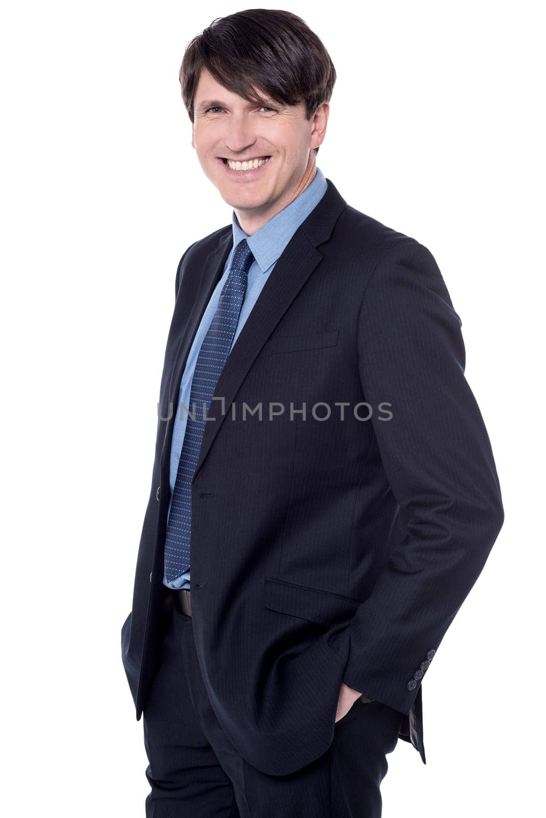 Happy businessman isolated on white with hands in pockets