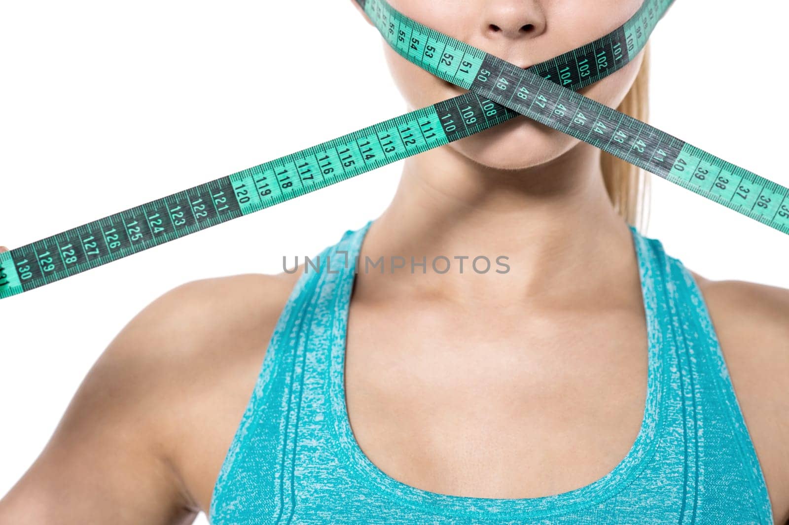 Woman covering mouth with measuring tape