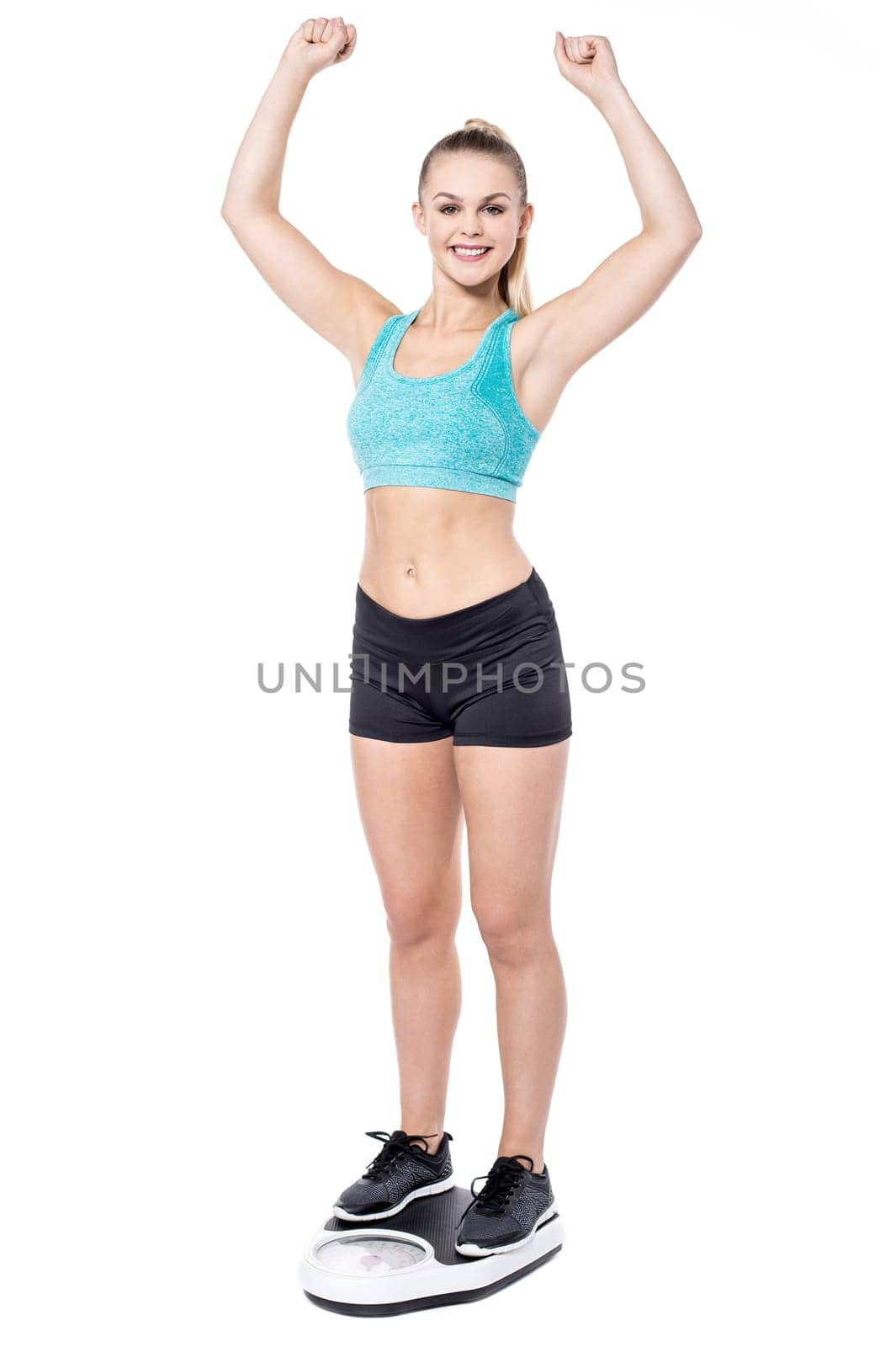 Young woman standing on weighing machine