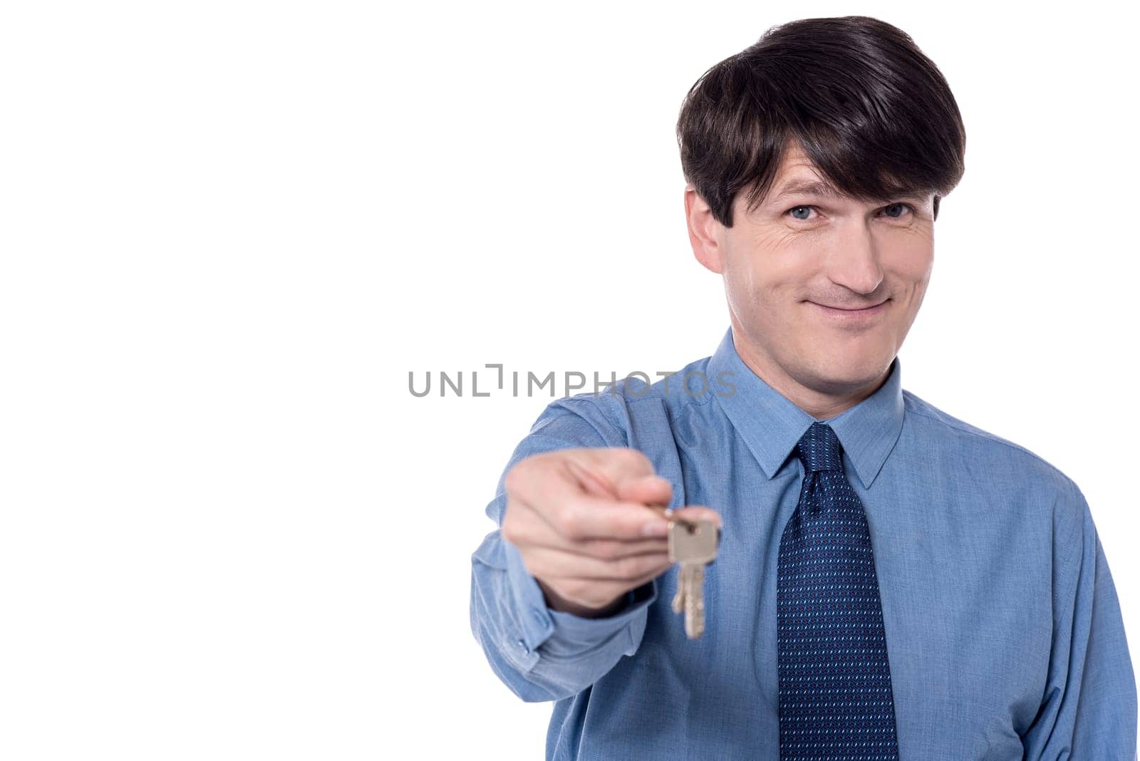 Smart executive offering house key over white
