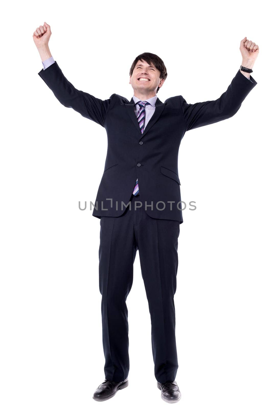 Successful businessman clenching fists