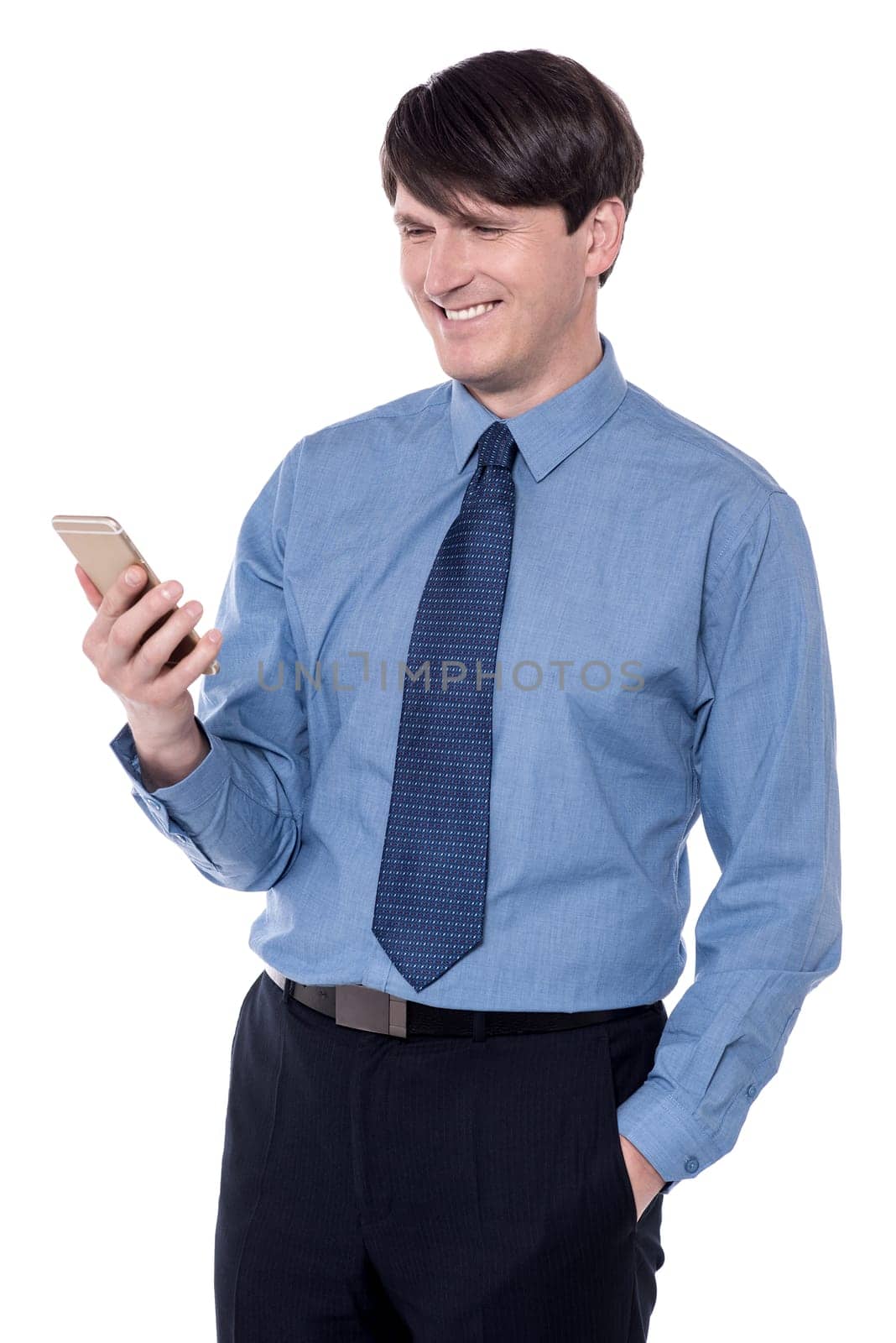 Smiling corporate executive looking at his cell phone