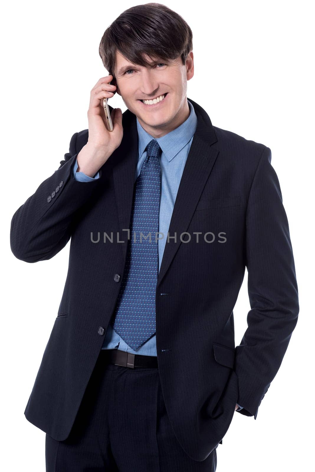 Happy businessman talking in smart phone over white