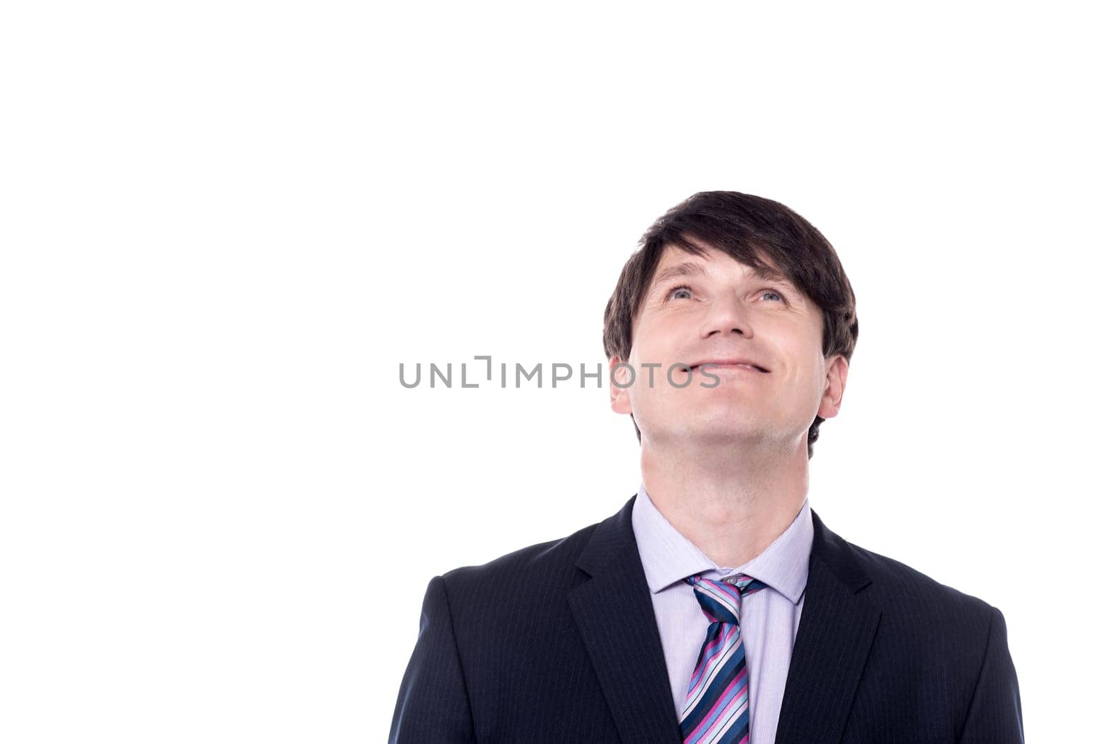 Portrait of a businessman looking upwards over white