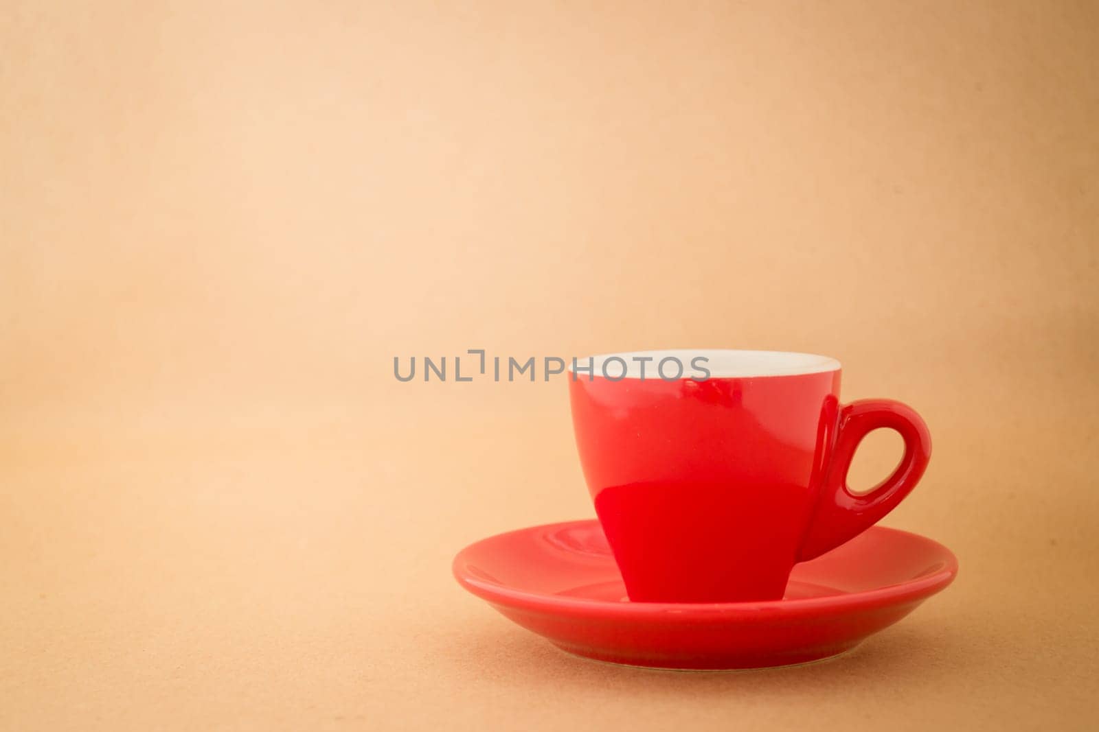 Beautiful red cup of coffee on vintage background, stock photo