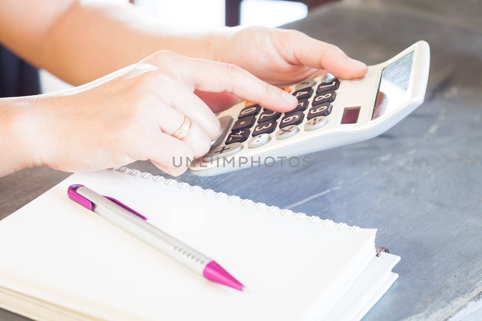 Hands holding and press calculator, stock photo