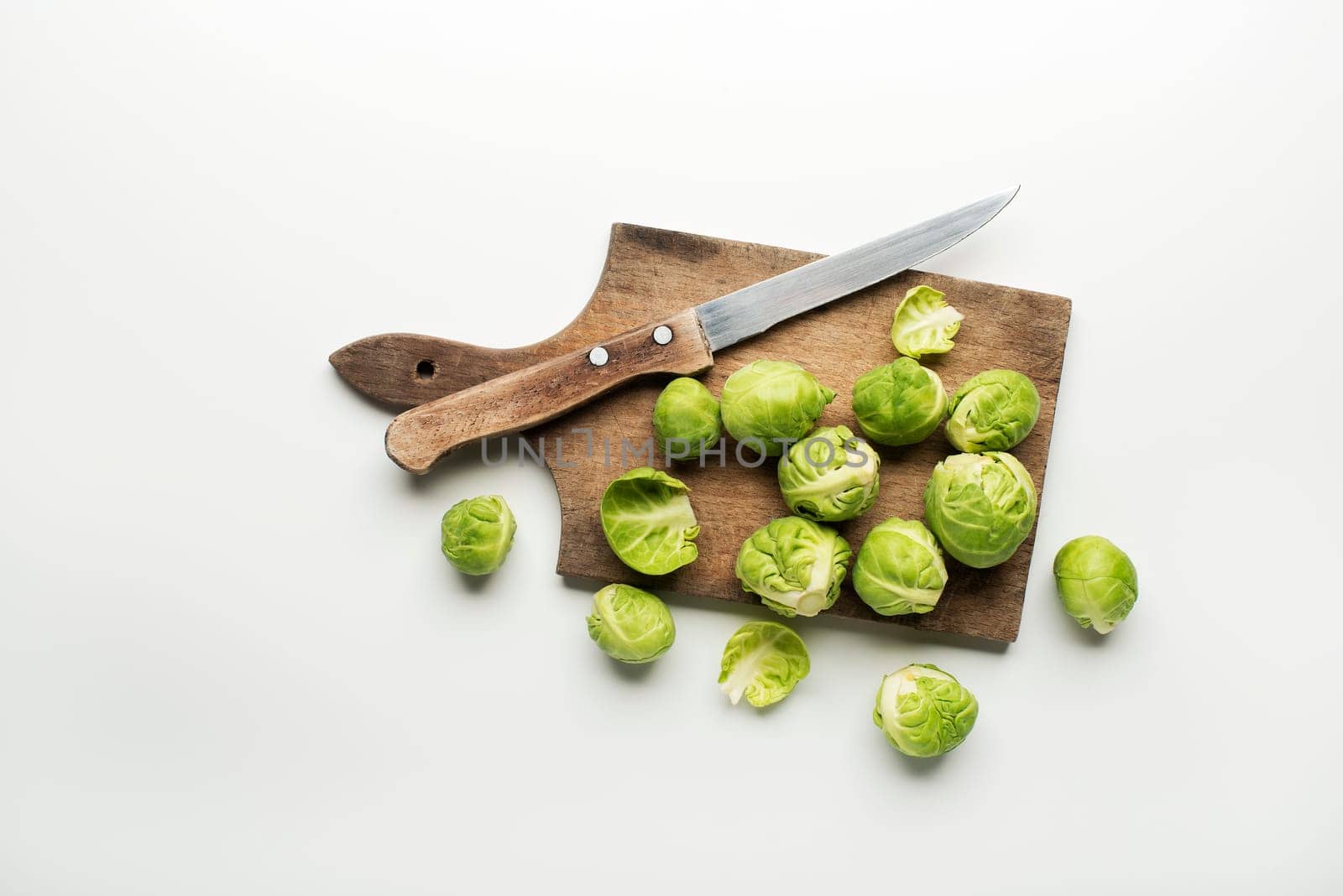 Fresh raw Brussels sprouts isolated on a white background.