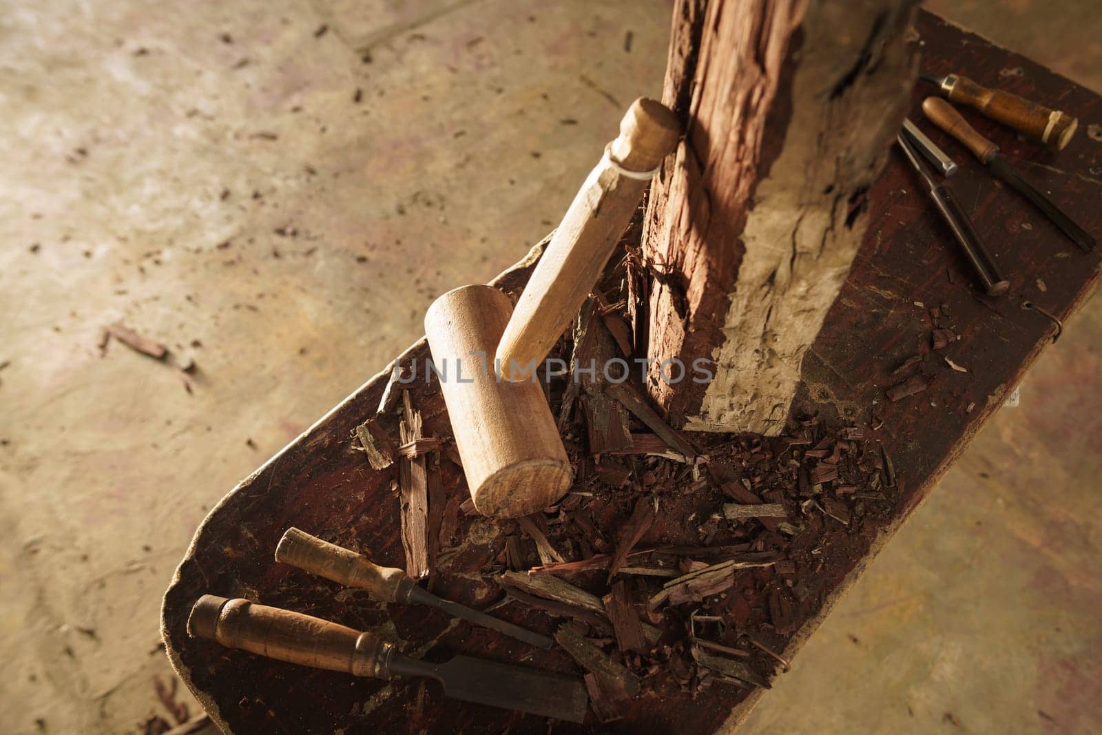 High angle view of artist tools, chisel and hammer for wood sculpture on desk.