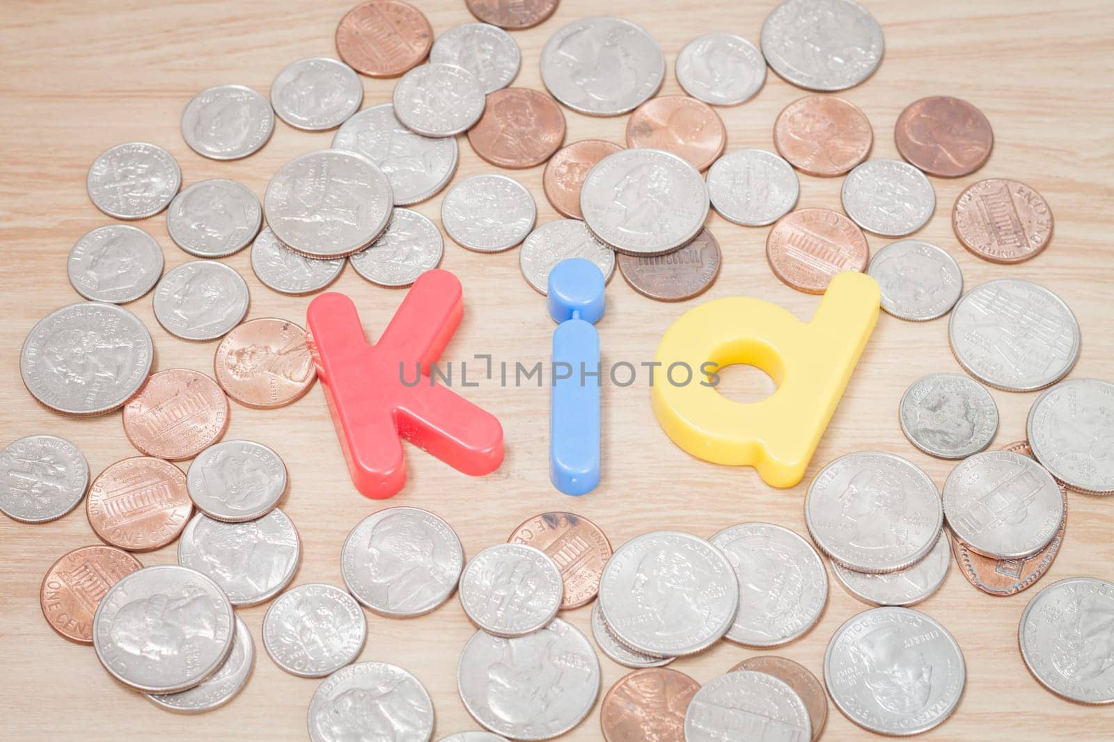 Kid alphabet with various US coins, stock photo