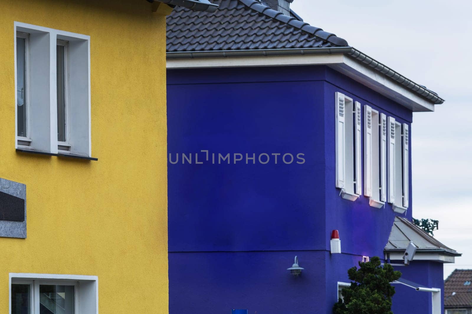 Side view of two houses overlooking an alarm system.