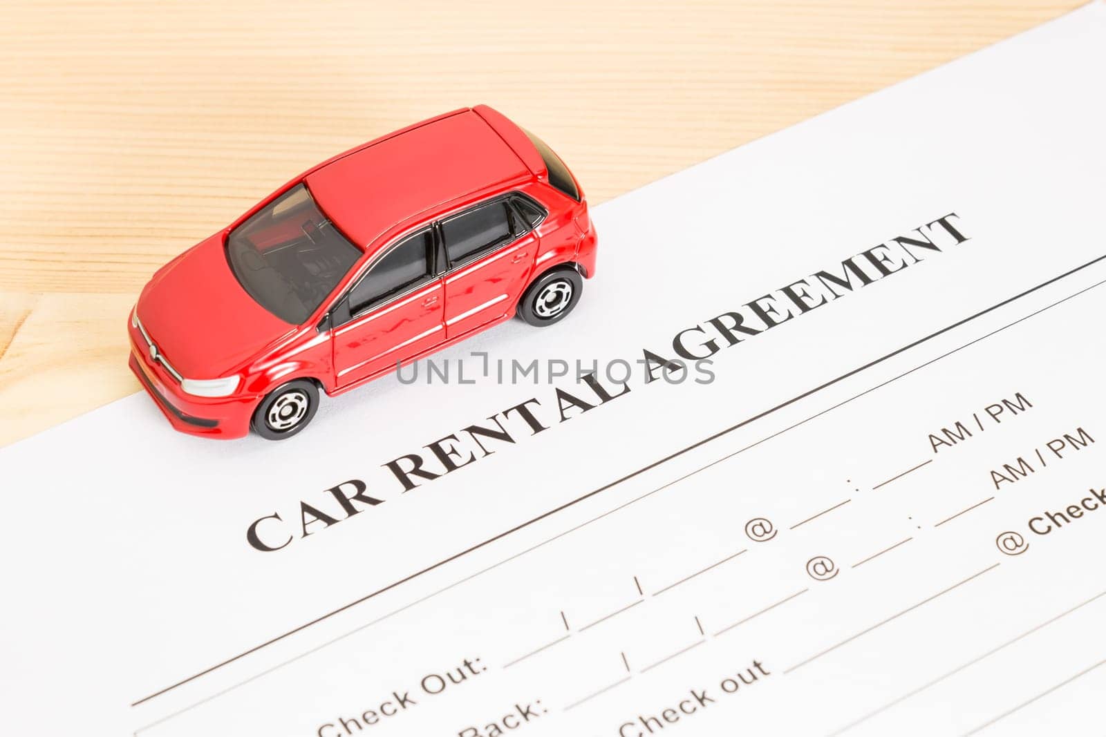 Car rental agreement with red car on left view. Auto rental agreement or legal document