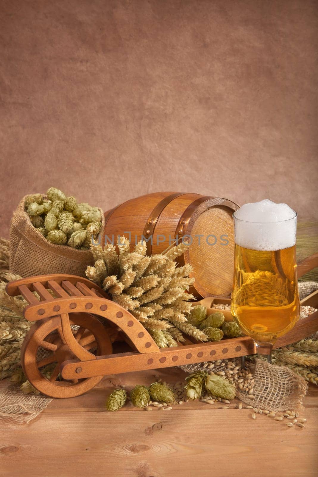 Beer glass with barrel,wheelbarrow,wheat,barley,hops and malt