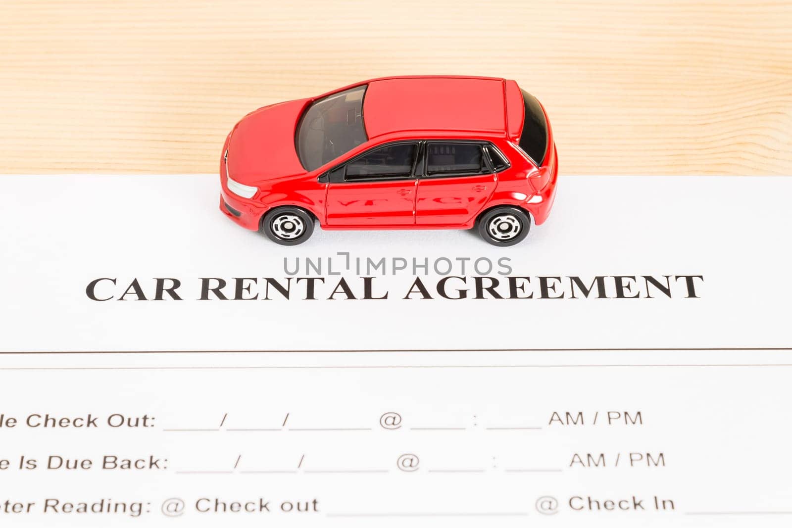 Car rental agreement with red car on center. Auto rental agreement or legal document