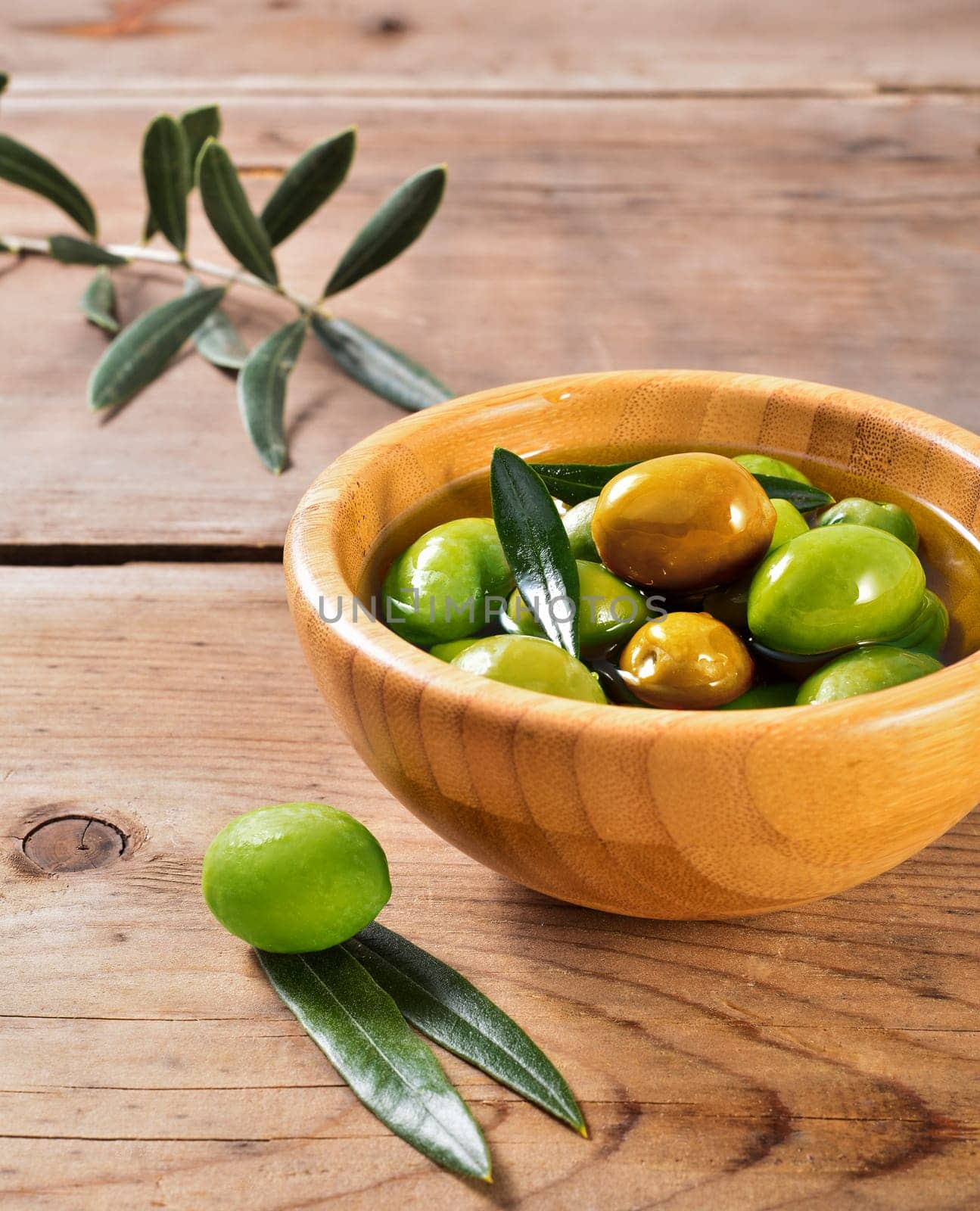 fresh olives in a jute bag, placed on a rustic wooden table. Olives from Sicily, Italy