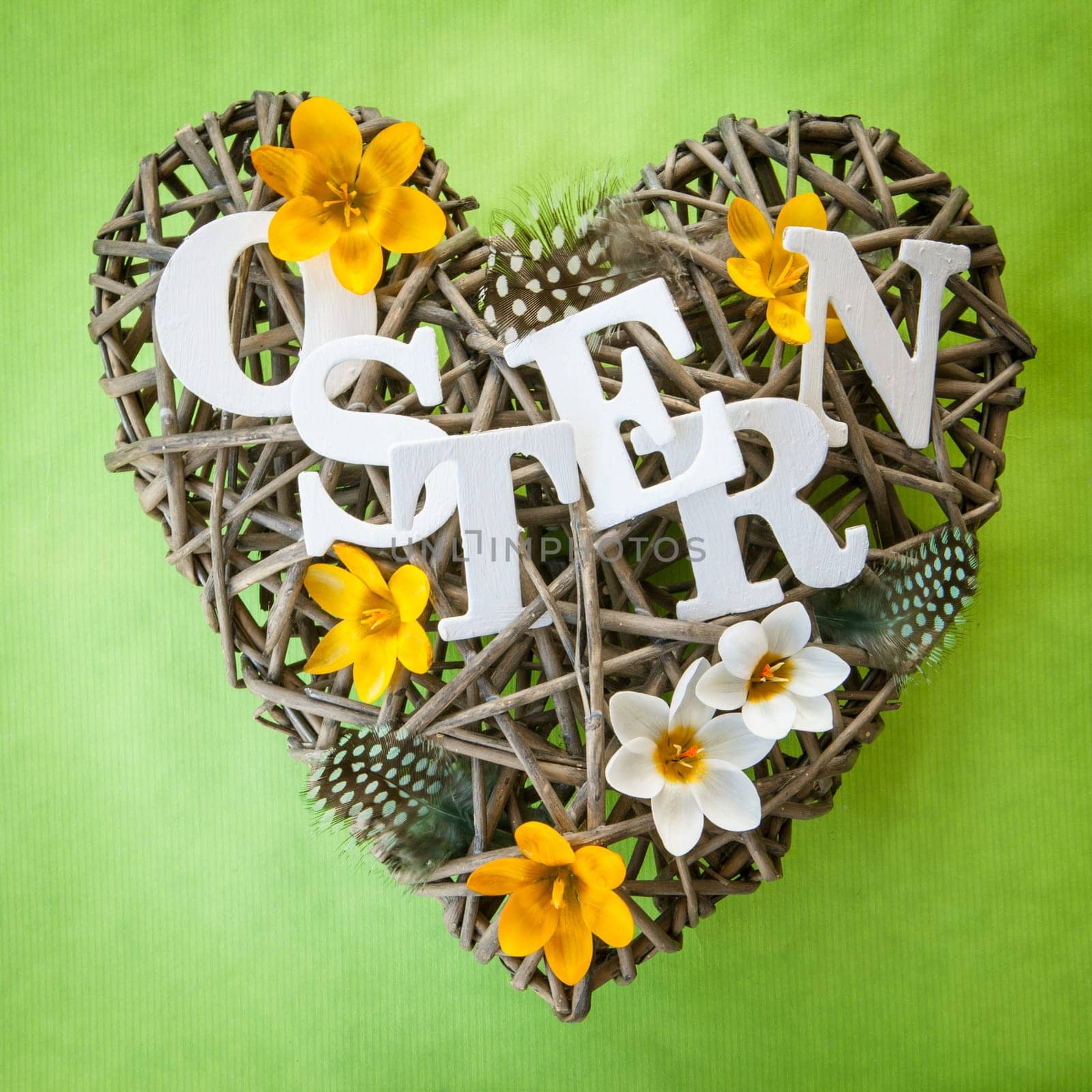 Heart of branches with feathers and crocus at Easter