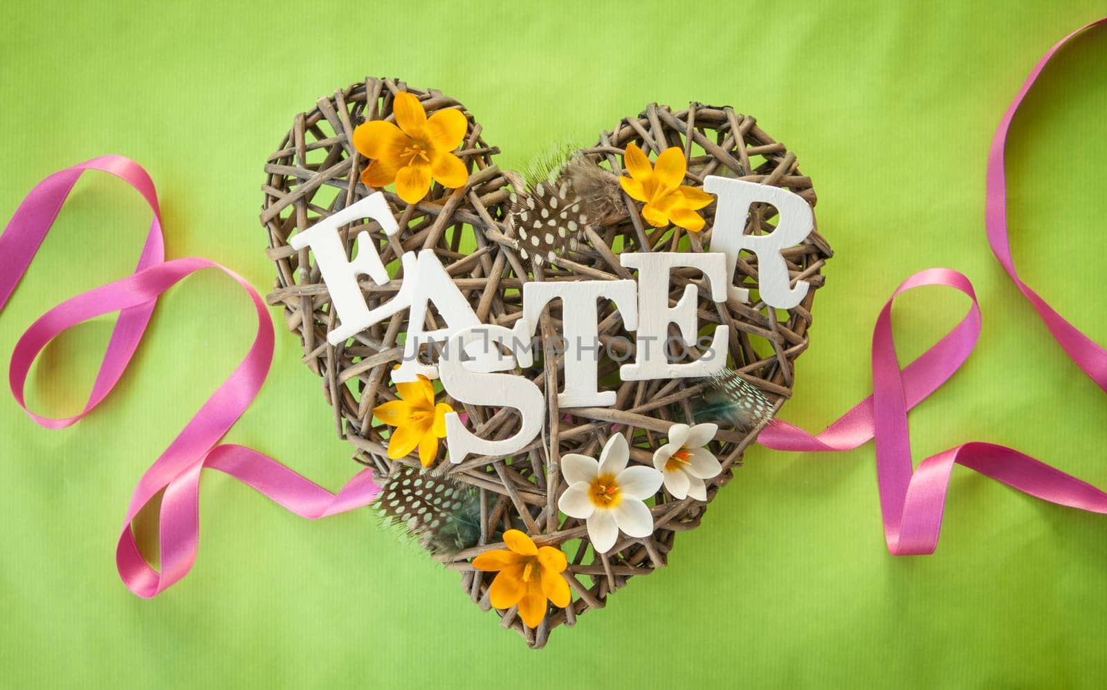 Heart of branches with feathers and crocus at Easter