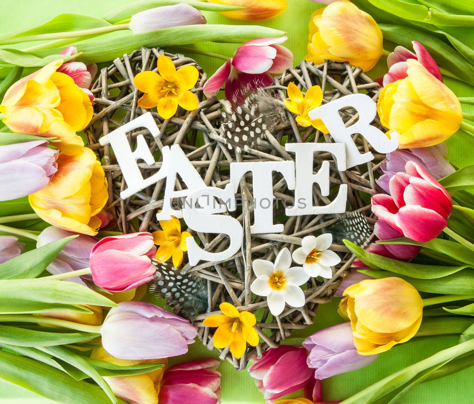Heart of branches with feathers and crocus at Easter