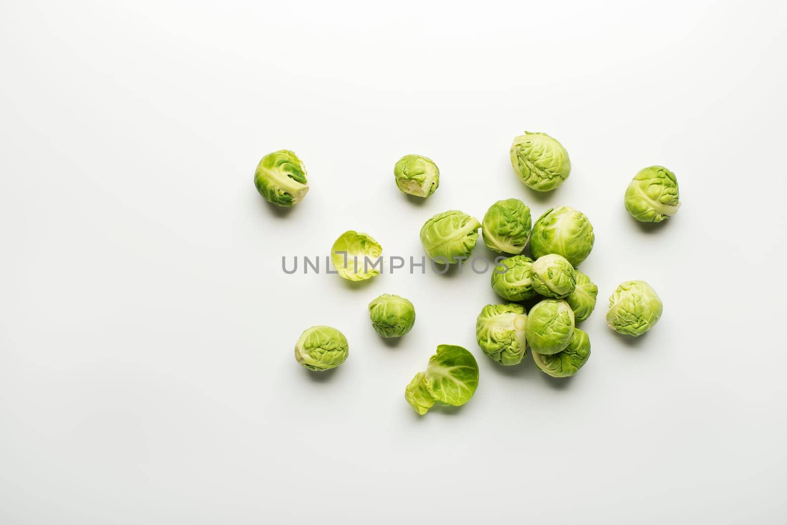 Fresh raw Brussels sprouts isolated on a white background.