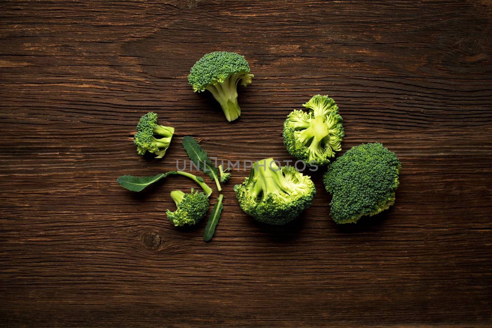 Fresh raw broccoli on a wooden background overhead shoot.