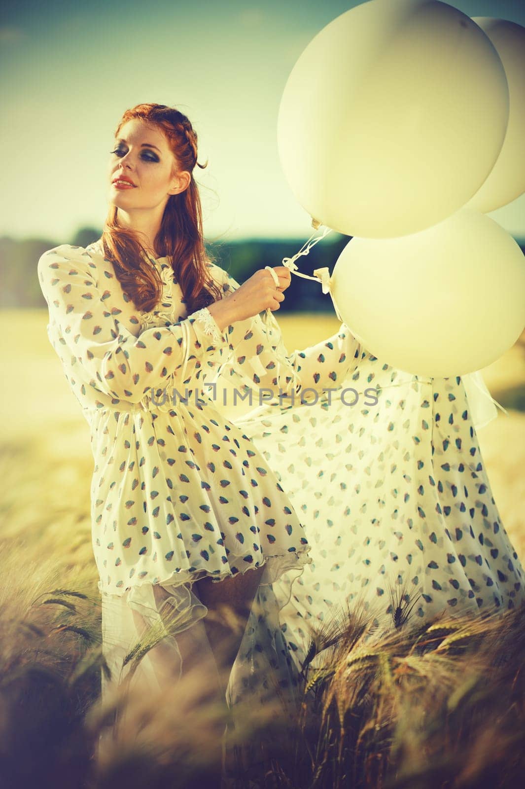attractive redhead woman with balloons