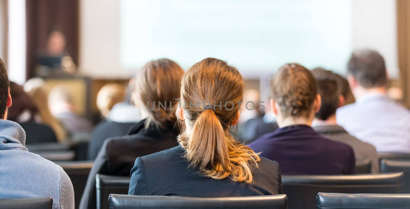 Speaker Giving a Talk at Business Meeting. Audience in the conference hall. Business and Entrepreneurship. Panoramic composition suitable for banners.