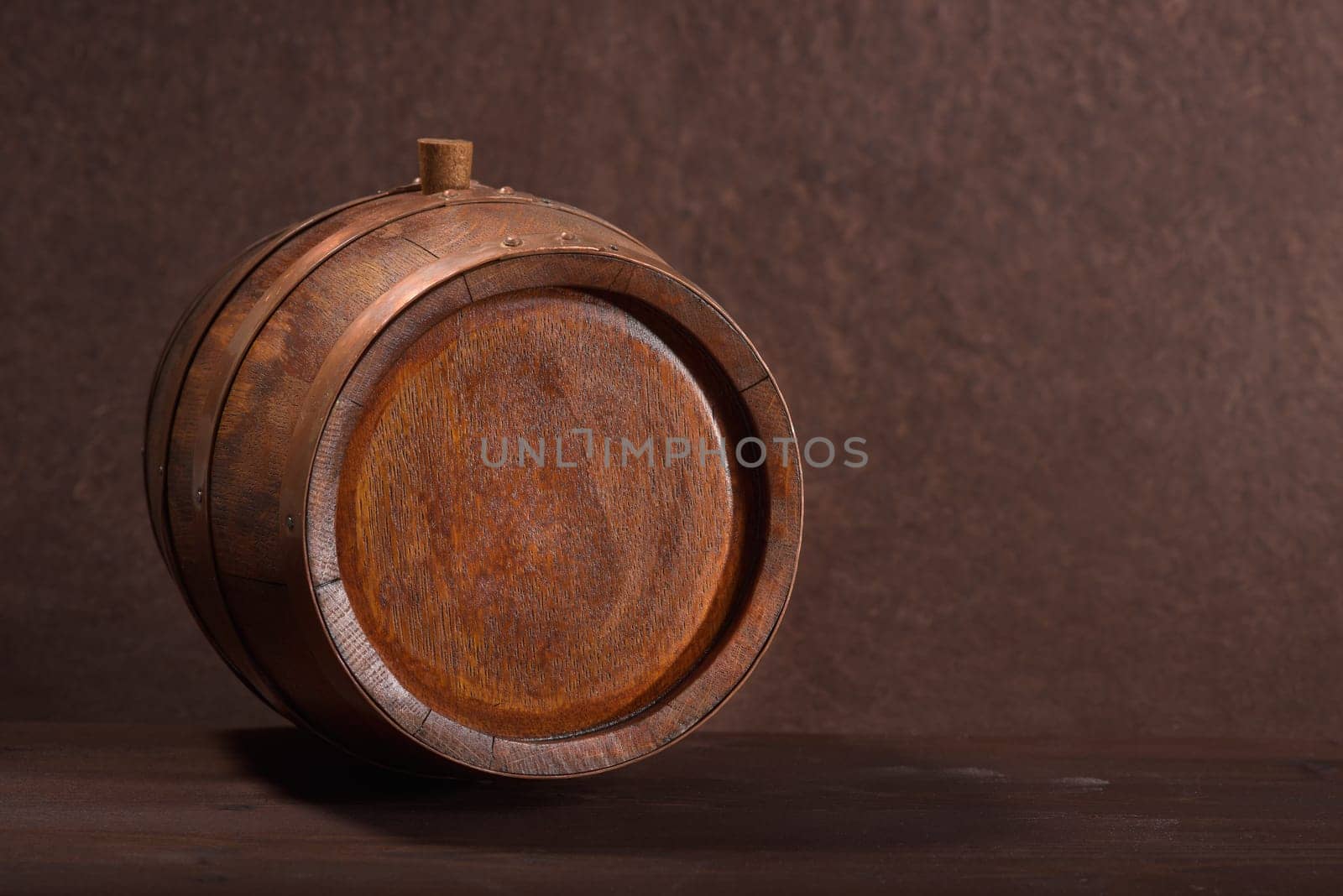 Old wooden barrel with copper rings and wooden plugs