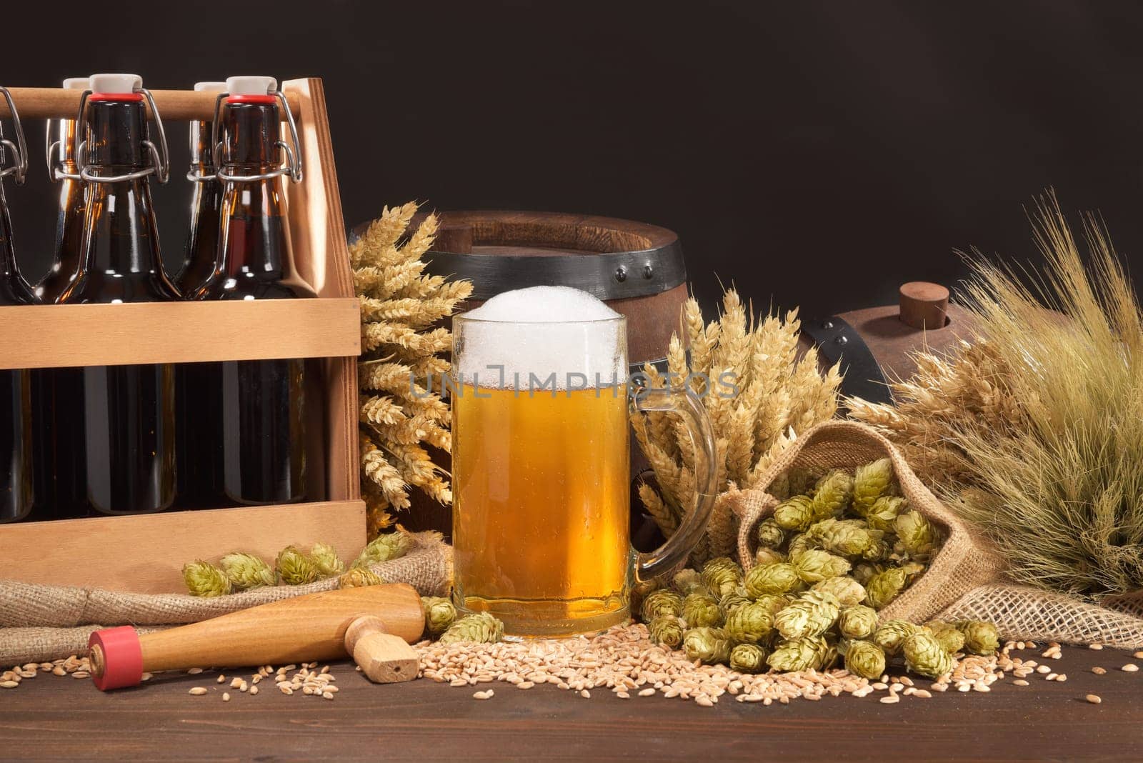 Beer carriers,beer barrels and beer glasses with wheat,barley,hops and malt