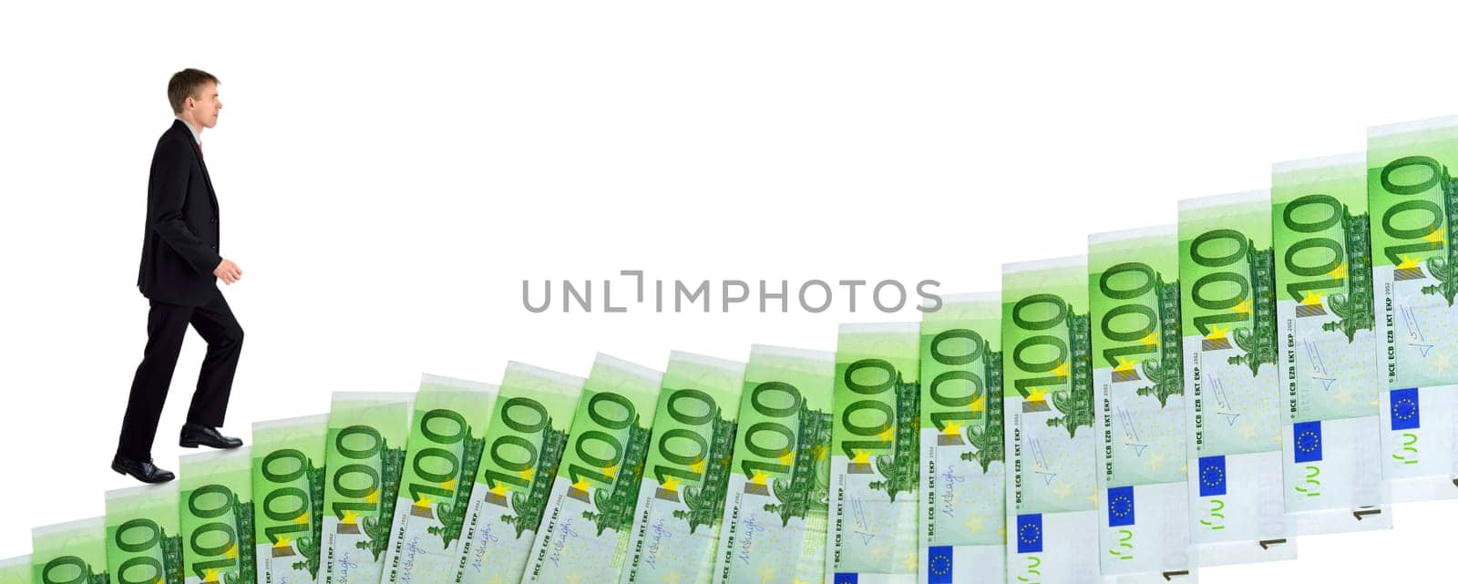 Isolated concept shot of a dynamic ambitious businessman climbing up banknotes arranged as stairs of success