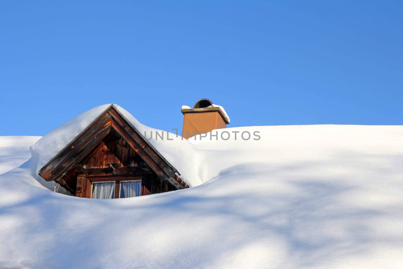 A snow-painted skylight of an old wooden house