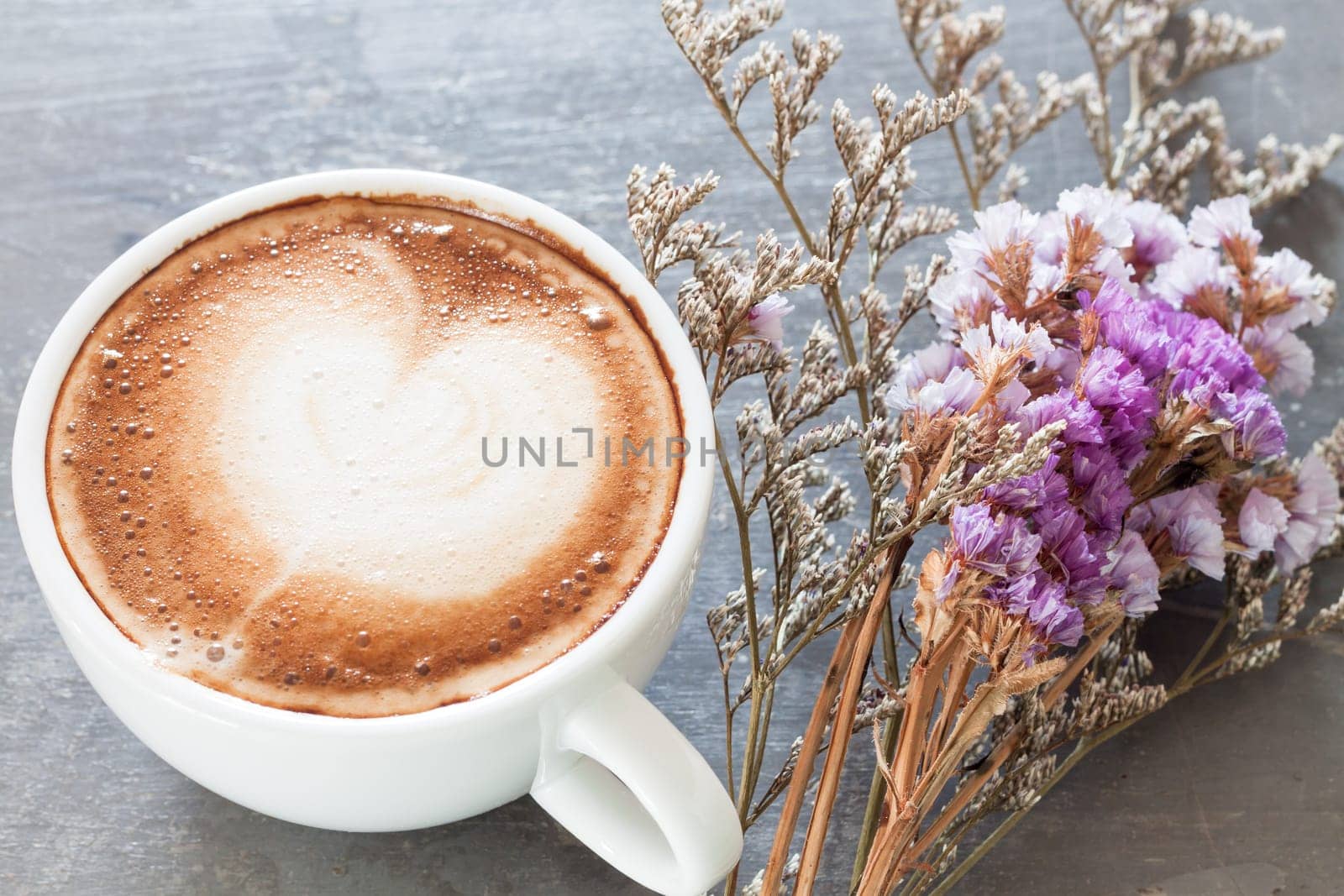Coffee cup with beautiful violet flower, stock photo