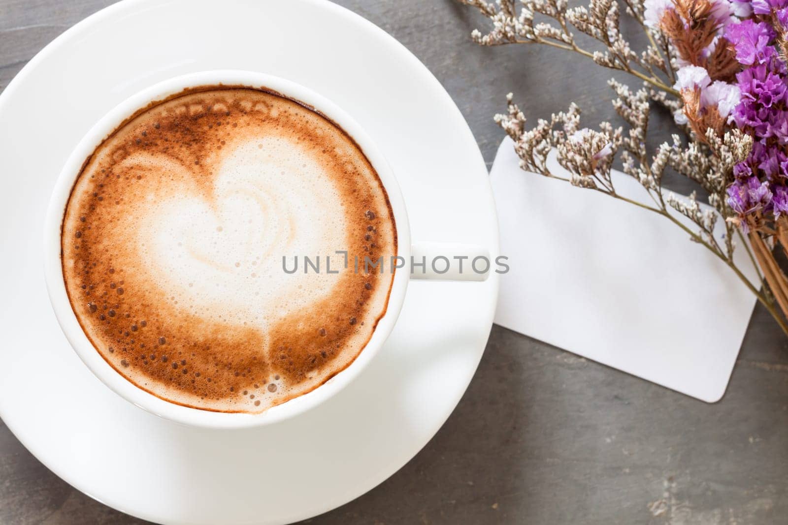 Coffee cup with name card on grey background, stock photo