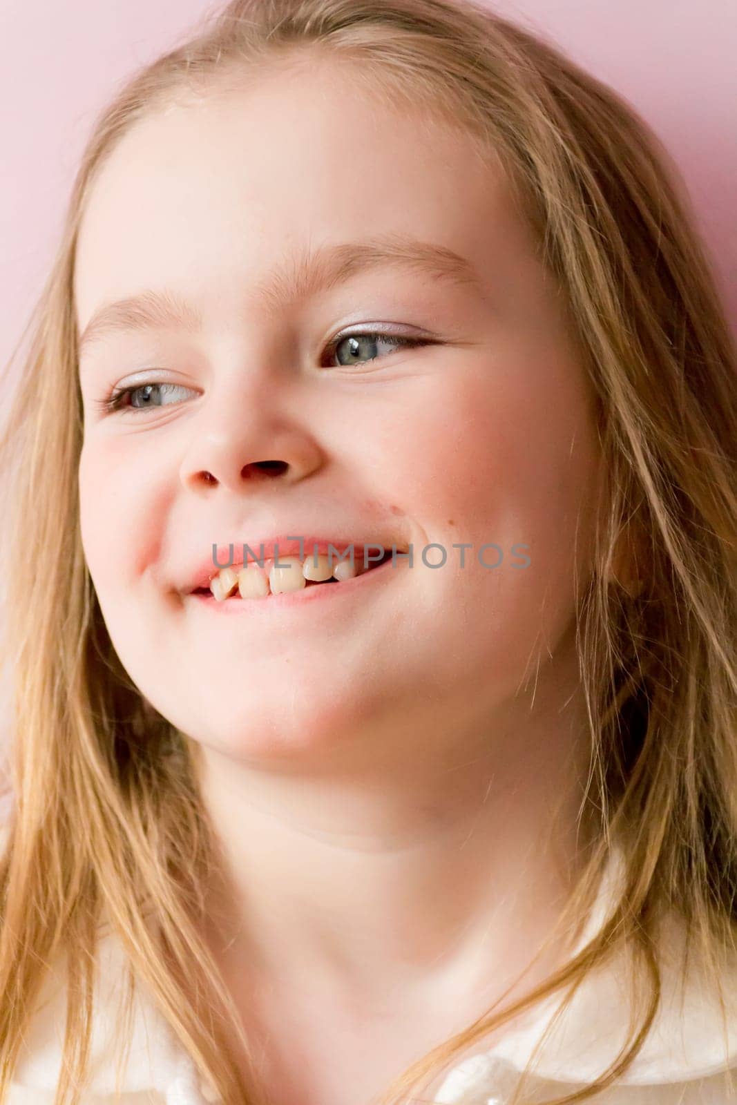 Portrait of cute smiling girl with blond hair