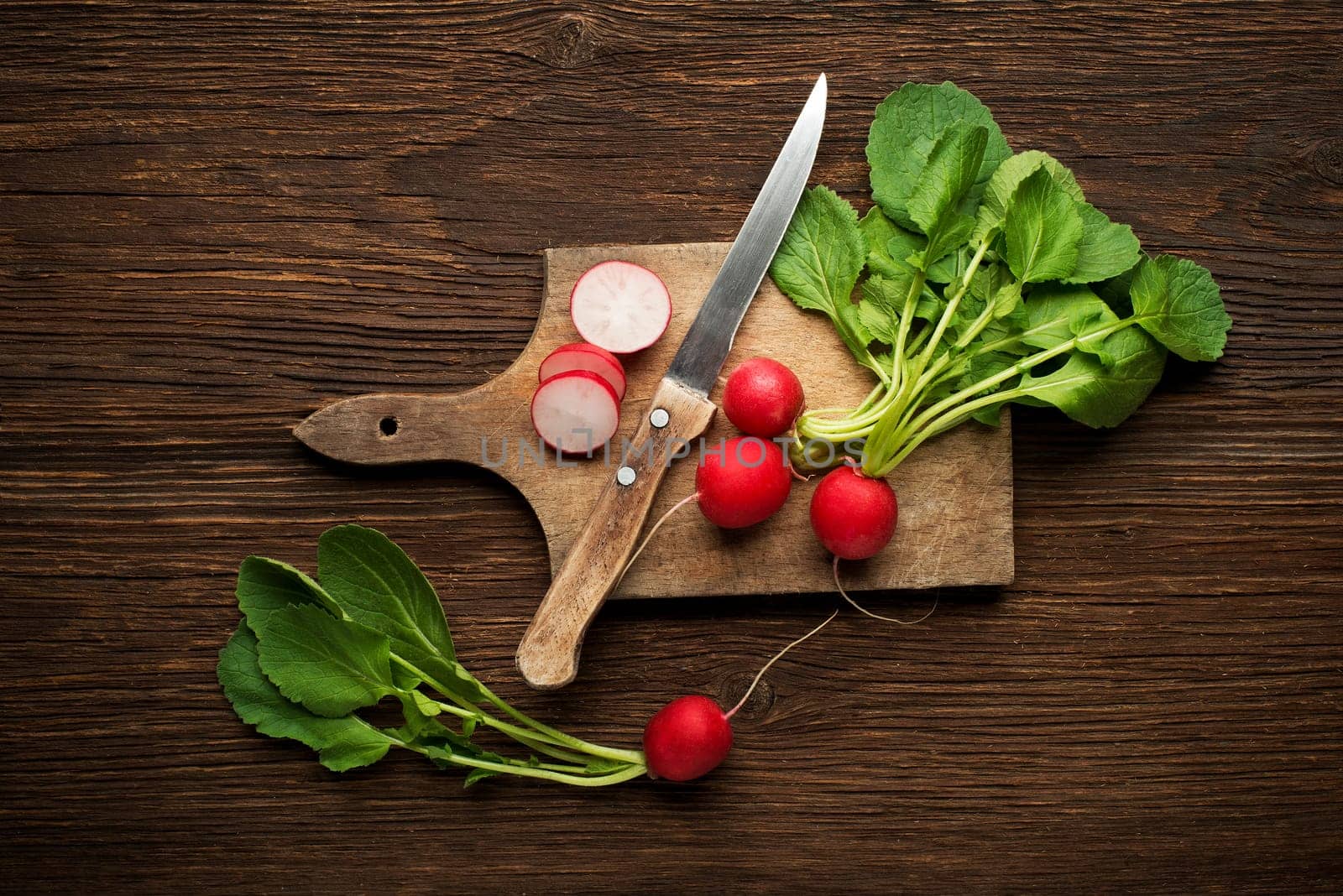 Fresh red radish on wooden background close up