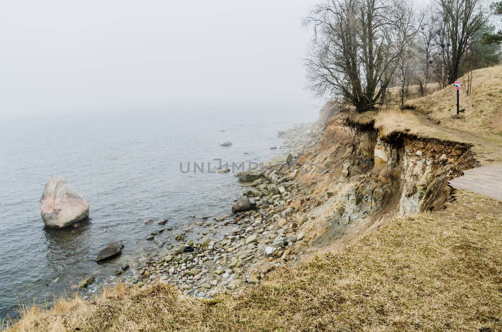 The road breaks at the seacoast destroyed by waves
