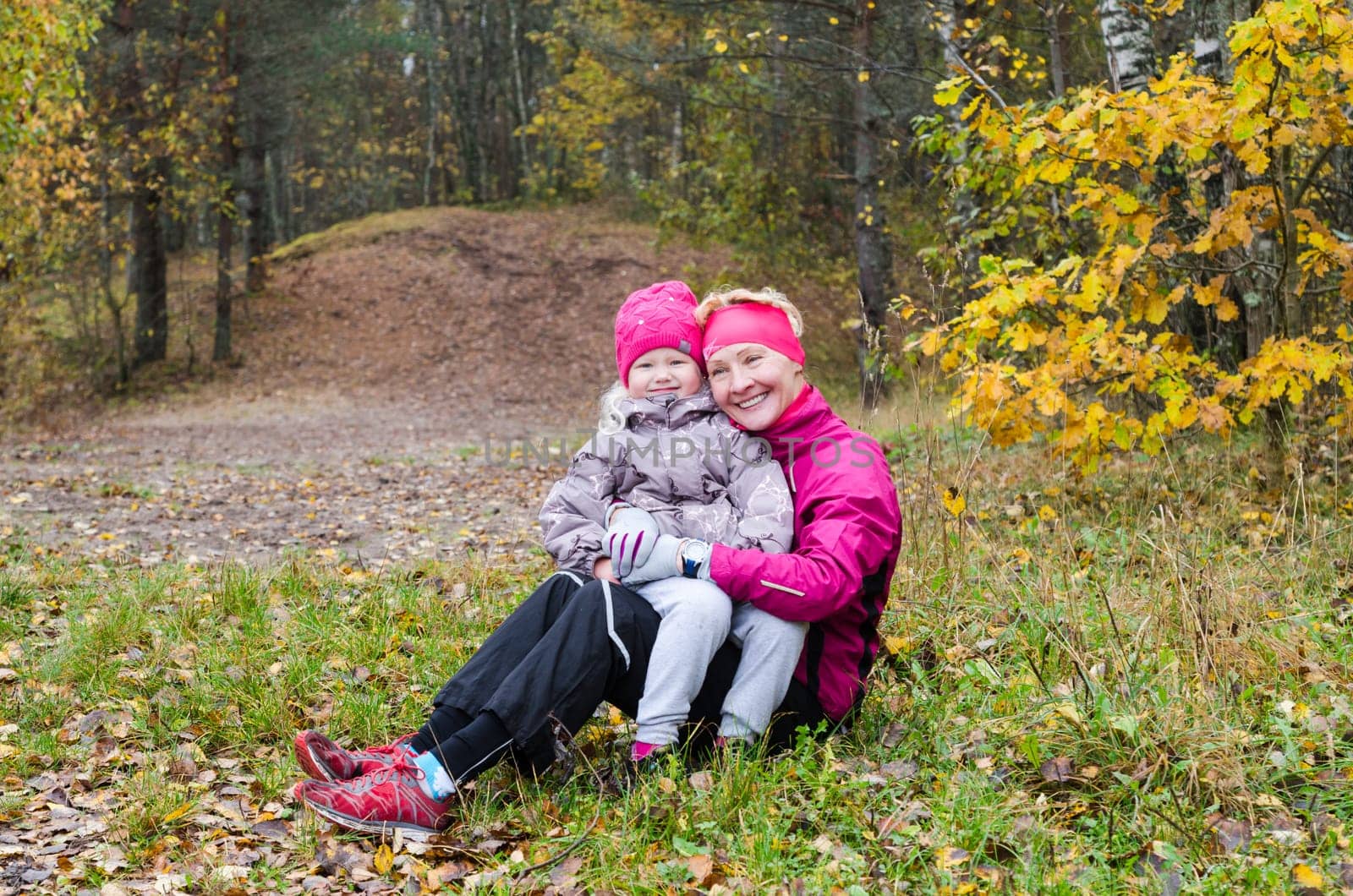 Grandmother with her granddaughter in the autumn park