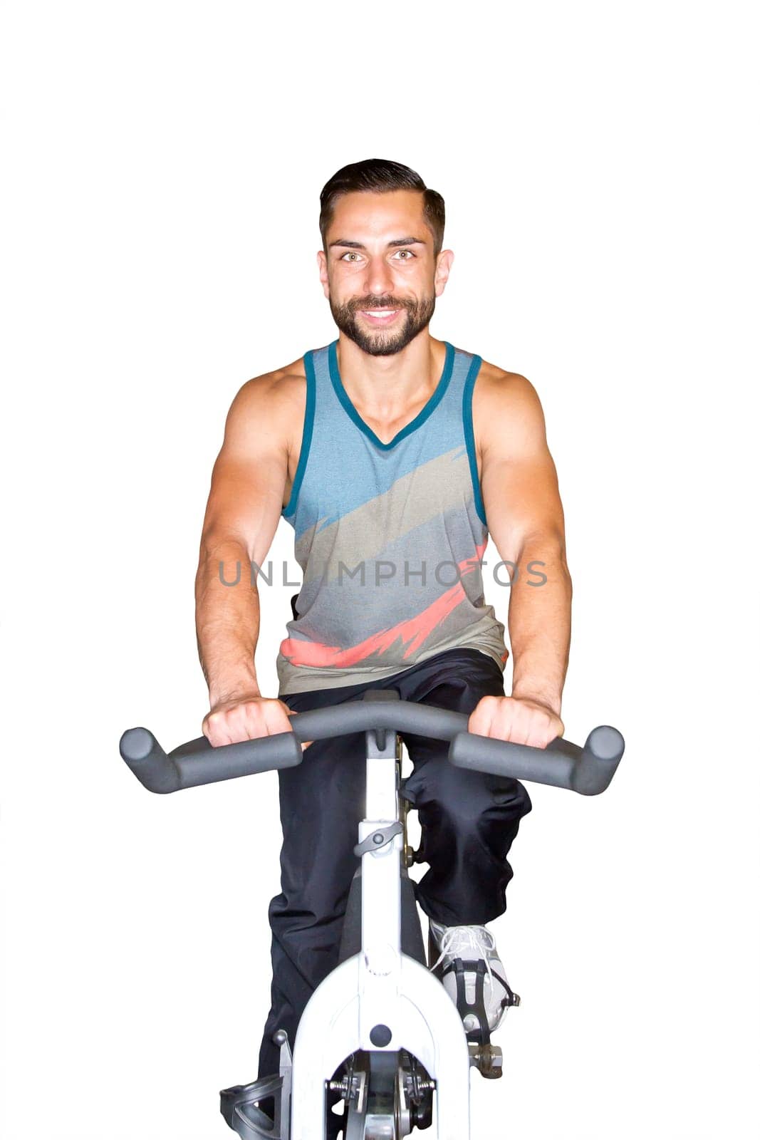 Young athletic man on training on the ergometer