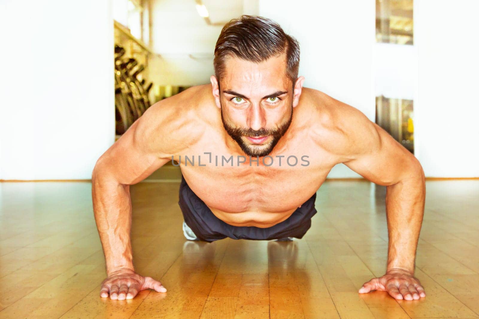 Young athletic man makes push-up